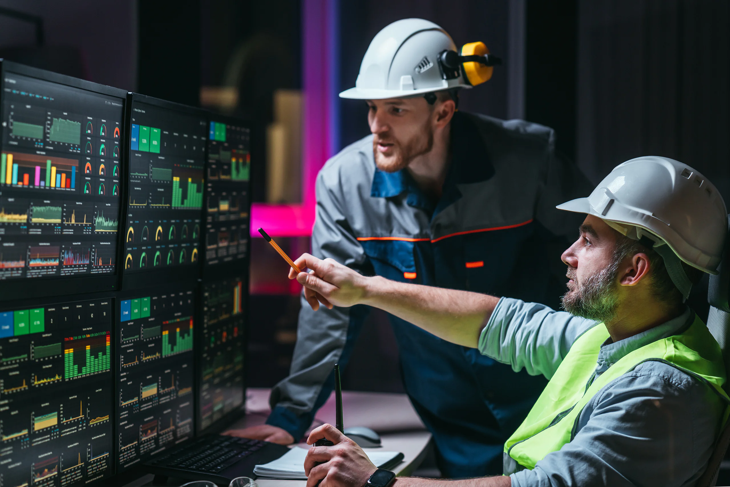 Maintenance professionals reviewing digital maintenance data and performance dashboards